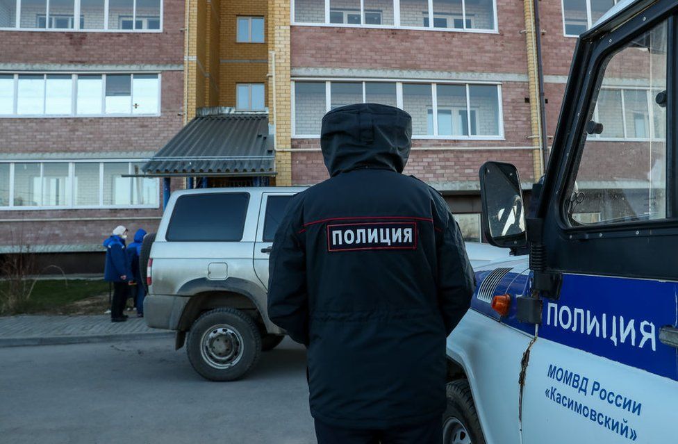 A policeman at the scene of the shooting in the village of Yelatma, Russia