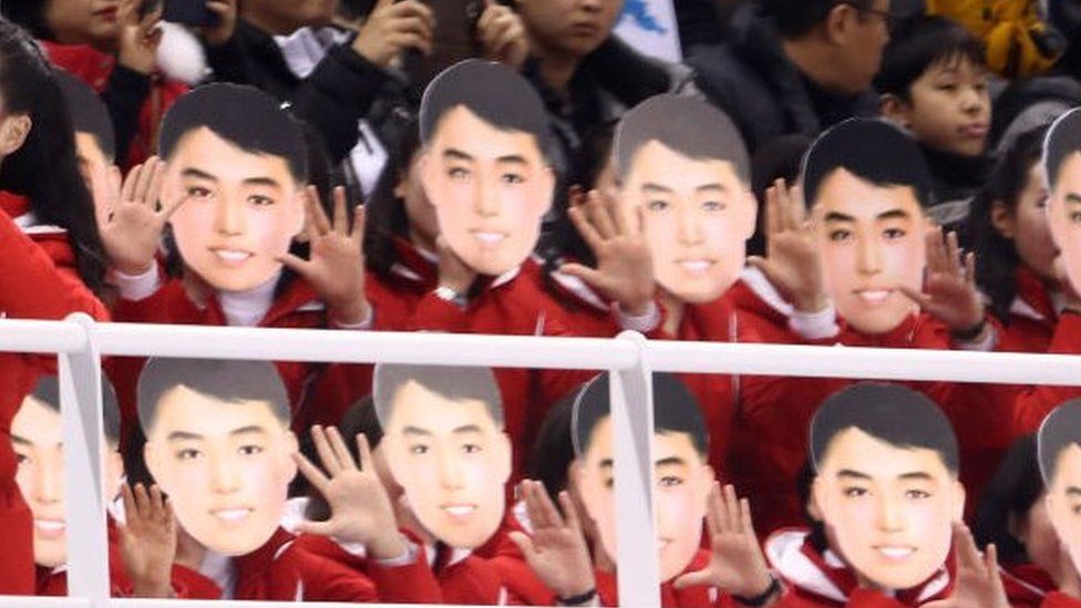 North Korean cheerleaders wearing masks during the ice hockey match