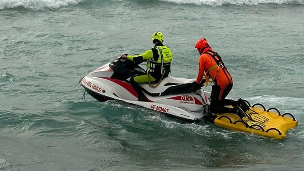 Italian authorities conduct a search after a migrant boat sank off the coast of Calabria