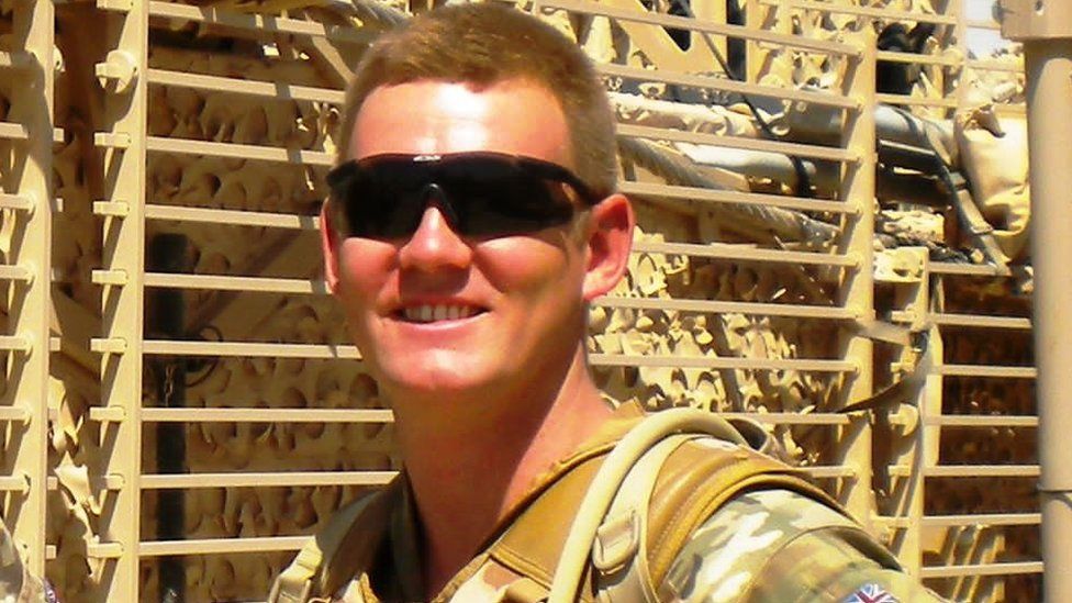 James Dieterle on deployment in Afghanistan in his uniform and wearing sunglasses