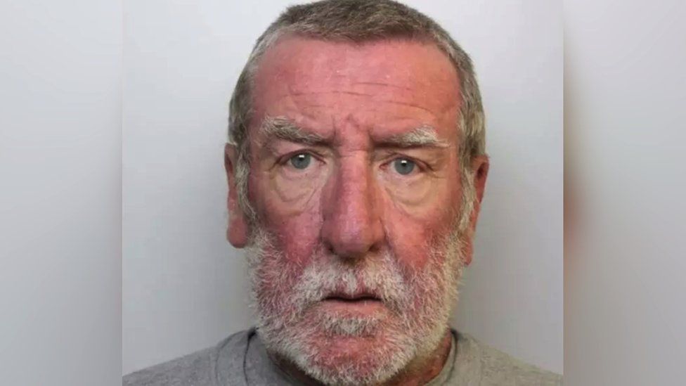 Mugshot of Simon Steeves. He has grey hair and a grey beard.