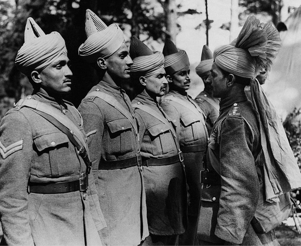 Types Of Indian Soldiers Being Inspected By Their Officer. This series of pictures were taken of the B.E.F Indian troops "somewhere in England"; many of them have just arrived back from Dunkirk under the charge of Major Wainwright and Major Jermyn, two British officers. (