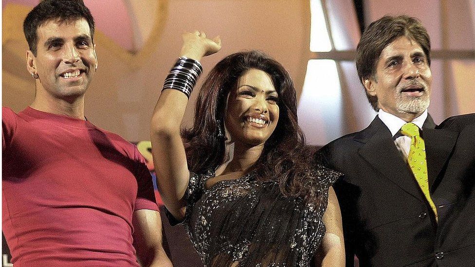 Indian movie star Amitabh Bachchan (R), Akshay Kumar (L) and actress Priyanka Chopra (C) wave during the ceremonial opening of the shooting of the film "Waqt; The Race Against Time" in Bombay, November 2003