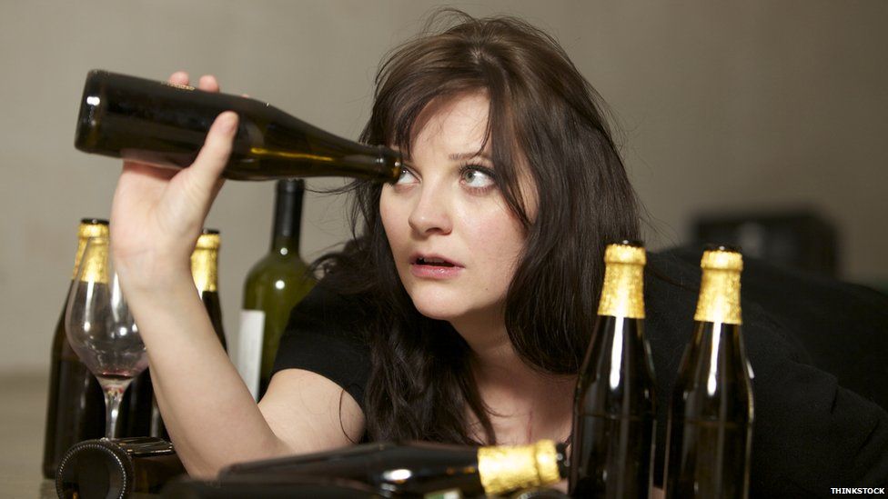 Woman with empty beer bottles