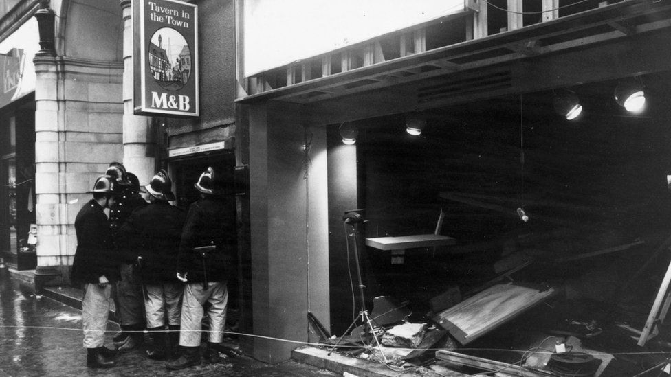 Firemen survey the damage outside the Birmingham pub, "Tavern in the Town"