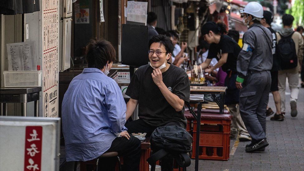 Diners eat at a restaurant in the Shinjuku district of Tokyo.