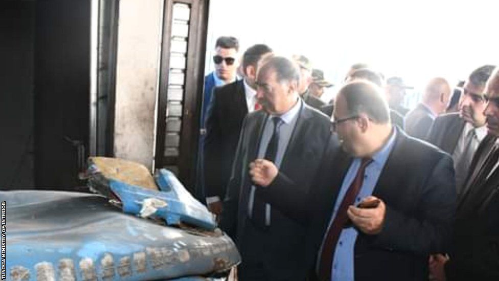 Kamal El-Feki, Tunisia's minister of interior being shown the damaged storeroom