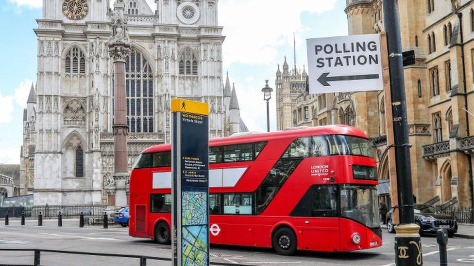 Polling station sign and a bus