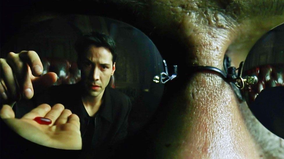 Keanu Reeves choosing the red pill in The Matrix