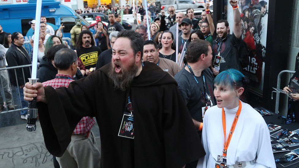 Ticketholders react as they file into the TCL Chinese Theatre for the opening night showings of Star Wars: The Last Jedi.