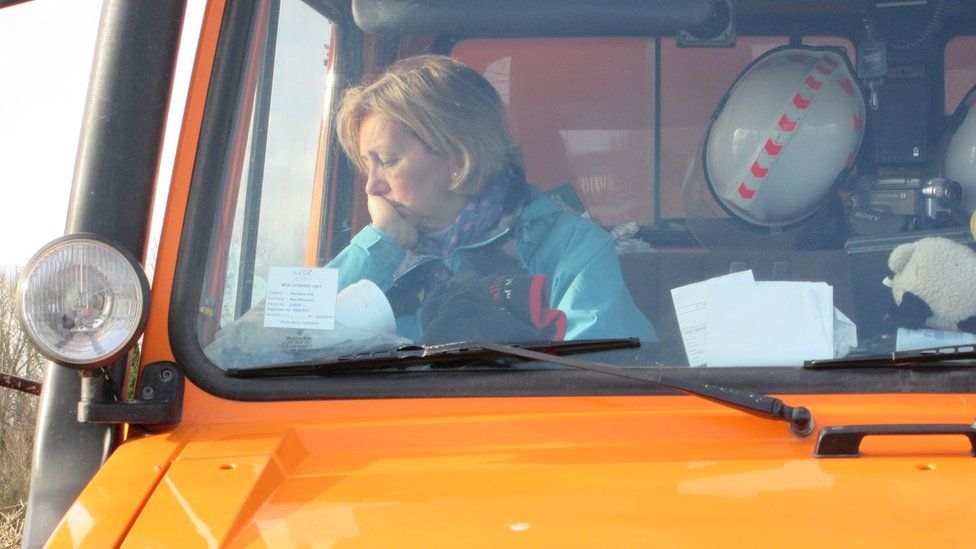 Lady looks concerned in massive flood rescue vehicle