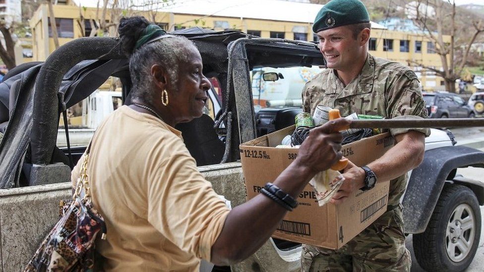 Captain George Eatwell drops off a box of aid for Mrs Harvey at Rainbow Home shelter, on the British Virgin Islands