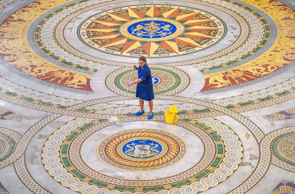 Louise Brewis cleans the Minton level  astatine  St George's Hall, Liverpool, earlier  it goes connected  show  to the public.