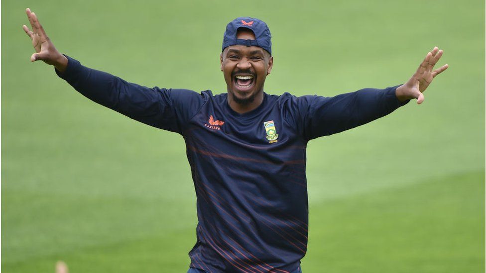 Khaya Zondo on pitch, grinning with arms outstretched.