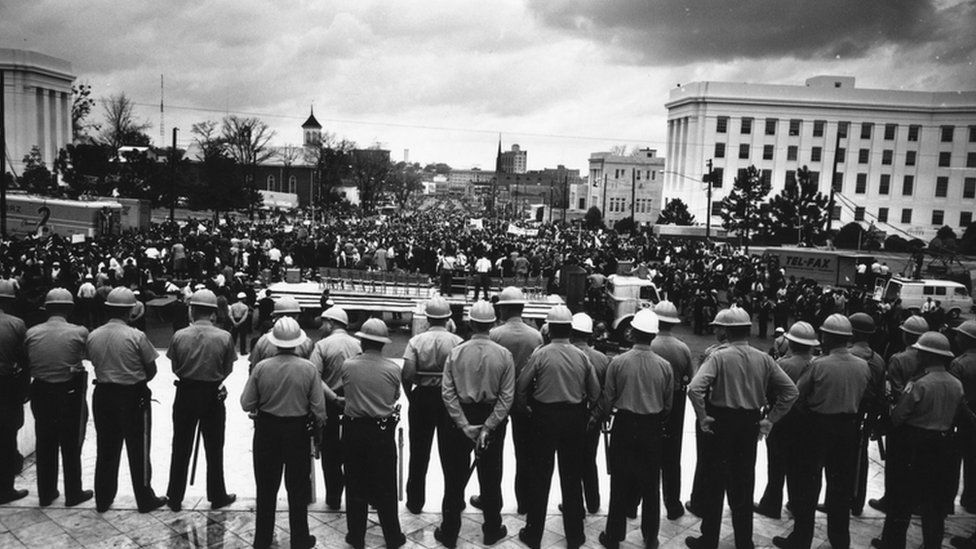 A line of policemen on duty during a black voting rights march in Montgomery, Alabama