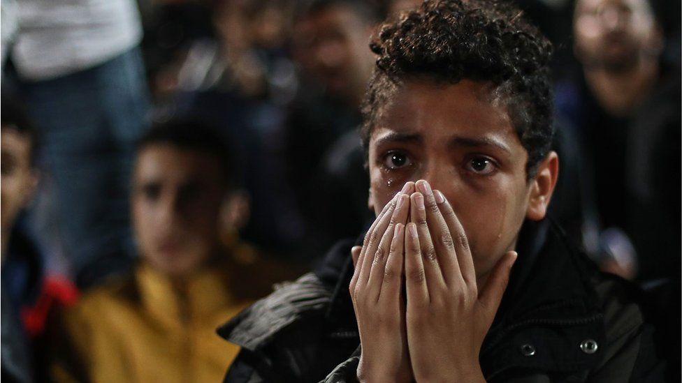 A young Egyptian fan crying as he watched the Senegal vs Egypt World Cup qualifying match. His hands are over his mouth in a scene of high emotion