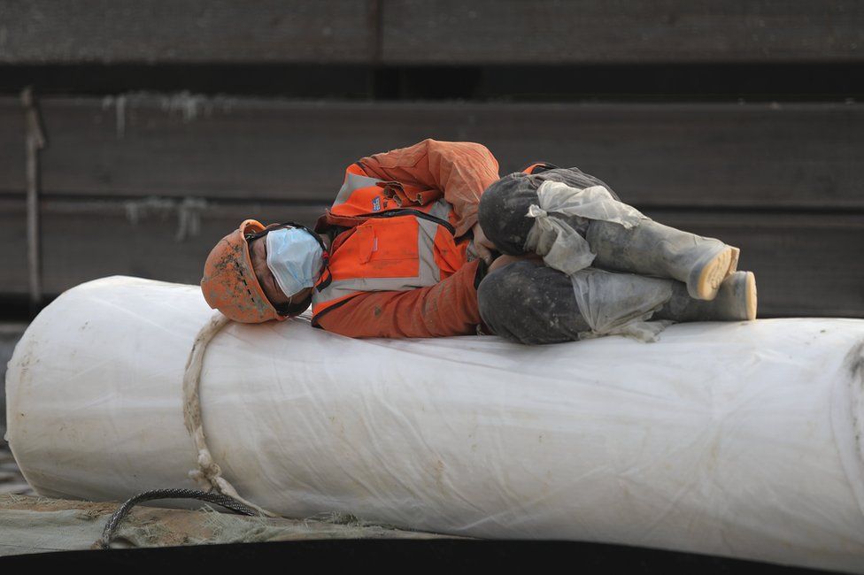 A construction worker rests