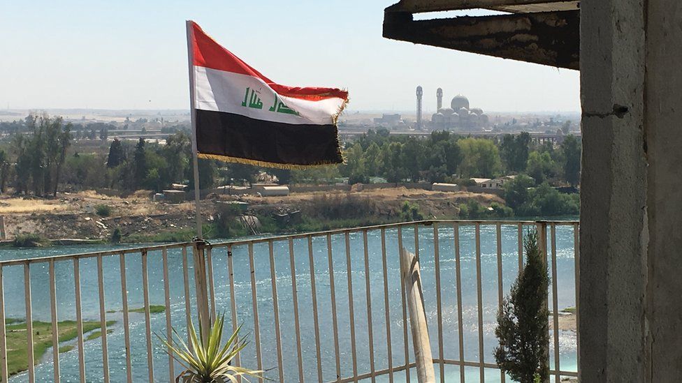 The Iraqi flag flying on the frontline on the banks of the River Tigris