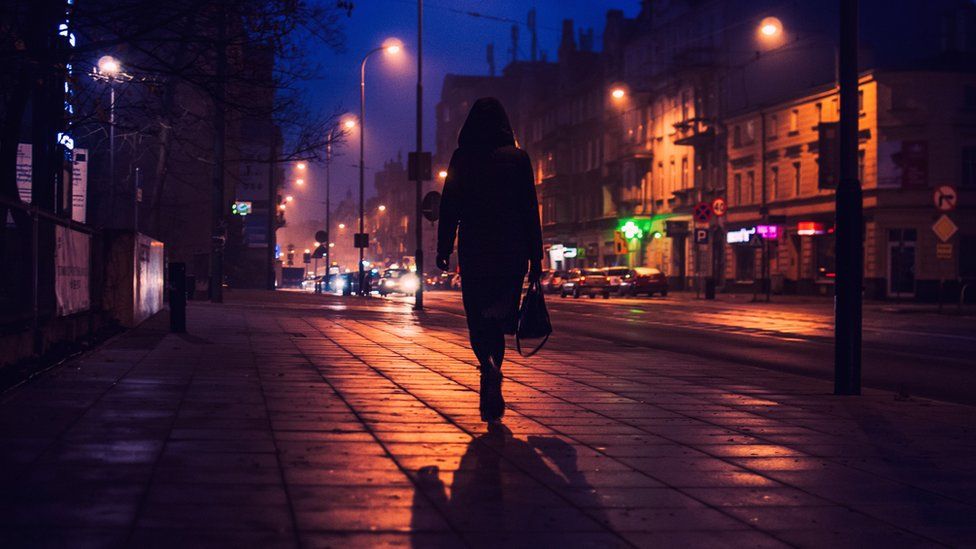 Woman walking at night