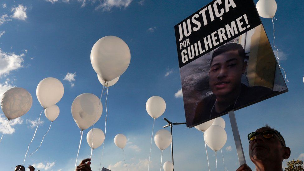 Protesters hold a 'Justice for Guilherme' sign after the 15-year-old was killed in Sao Paulo in June