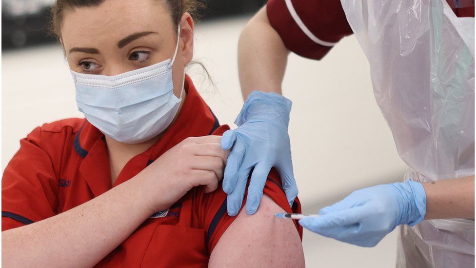 Joanna Sloan receiving the vaccine into her arm on 8 December 2020