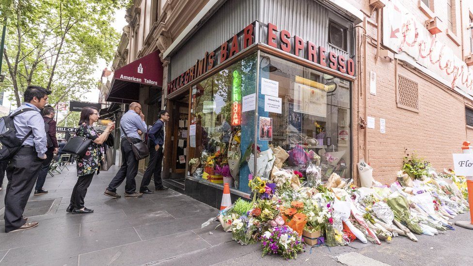 Customers and floral tributes outside Pellegrini's