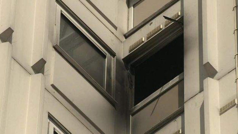 Smoke-damaged windows after tower block fire