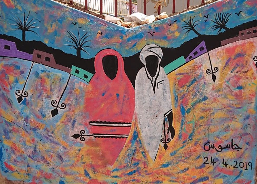 A mural of a man and woman on a wall in Khartoum, Sudan