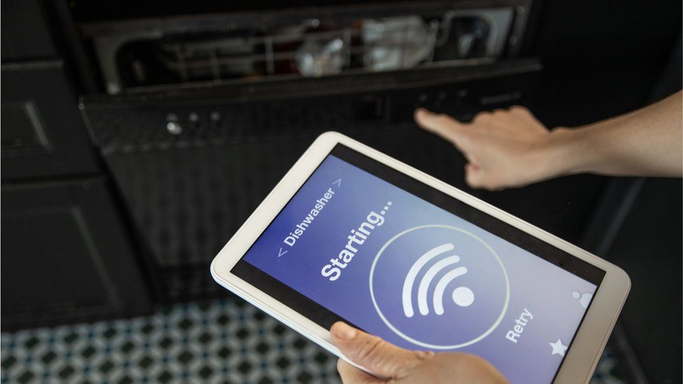 A smart dishwasher being controlled by a tablet