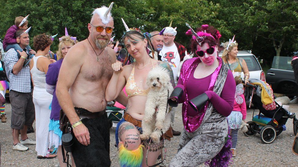 Matt Holdige, Sammy Harrison and Scarlett Lowin wearing unicorn horns with their small dog