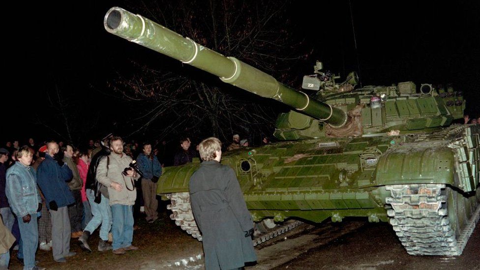 A Lithuanian demonstrator stands in front of a Soviet Red Army tank during the assault on the Lithuanian Radio and Television station on January 13, 1991 in Vilnius