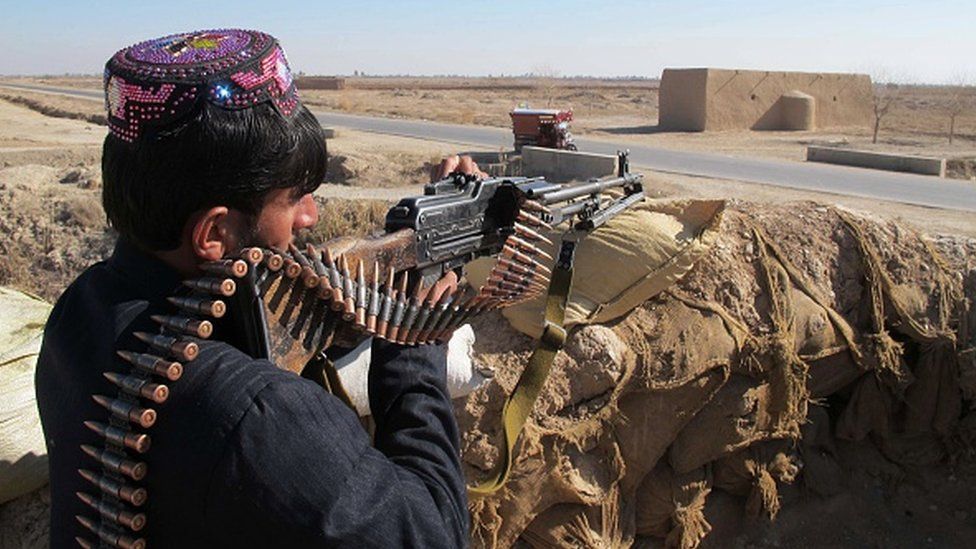 An Afghan Local Police personnel keeps watch during an ongoing battle with Taliban militants in the Marjah district of Helmand Province on 23 December 2015