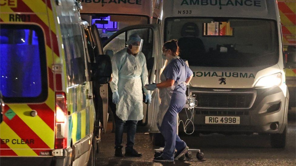 Medical staff attending to two patients in an ambulance, at Antrim Area Hospital, Co Antrim in Northern Ireland