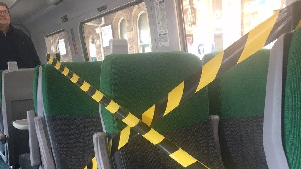 Shattered glass on seat cordoned off by yellow tape