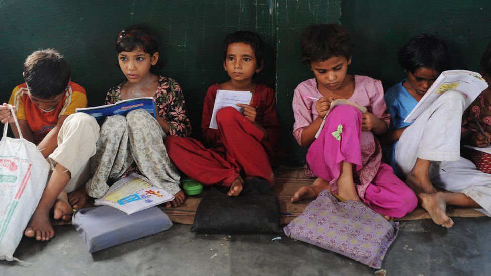 In a picture taken on August 30, 2012, Indian school children read in a classroom at a government school in Bagpath district in Uttar Pradesh.