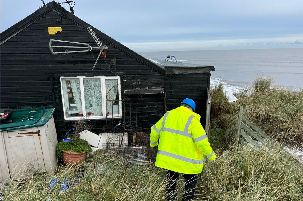 A council building control surveyor is assessing the weather conditions and if three properties are ready to be demolished