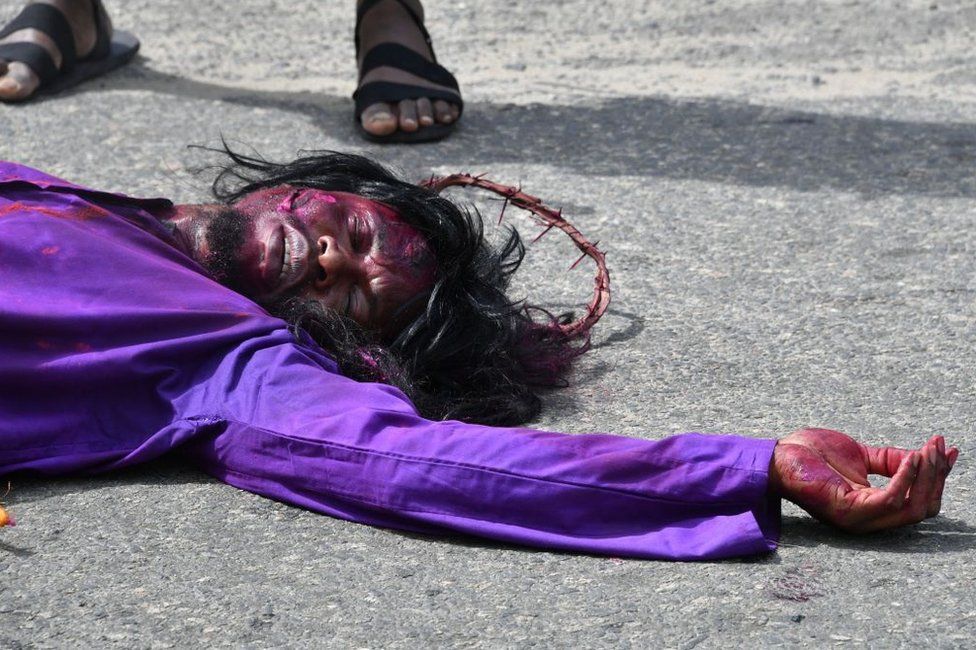 A worshipper takes part in the re-enactment of the passion of Christ during celebrations marking Good Friday.