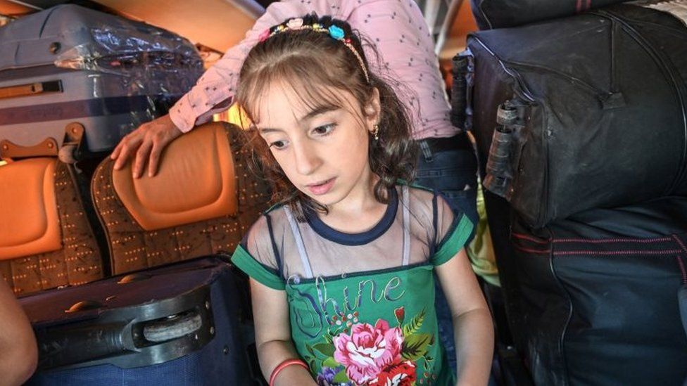 A Syrian girl waits inside a bus as Syrian refugees returning voluntarily to their country prepare to leave Istanbul, Turkey. Photo: August 2019