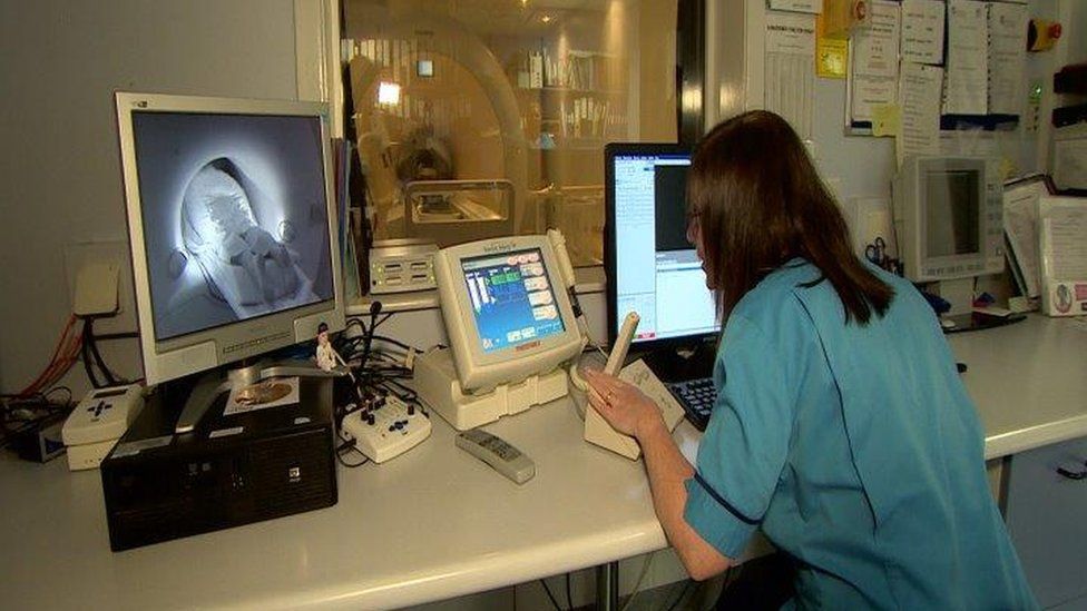 Nurse monitoring MRI scan