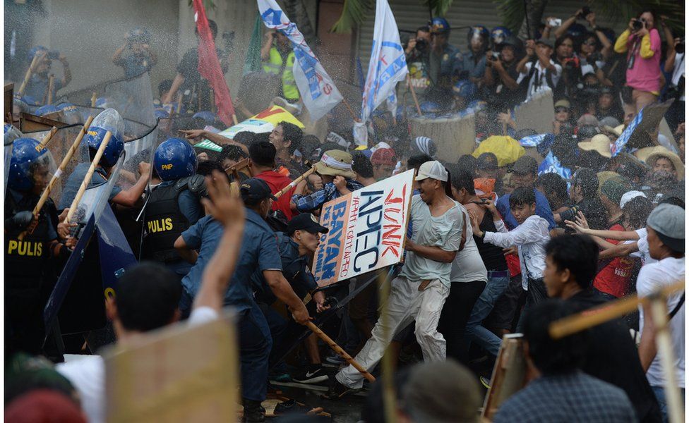 Philippine police fire water cannon as they clash with protesters parading down a street trying to voice their opposition to the Asia-Pacific Economic Cooperation (APEC) Summit currently taking place in Manila on 19 November 2015.