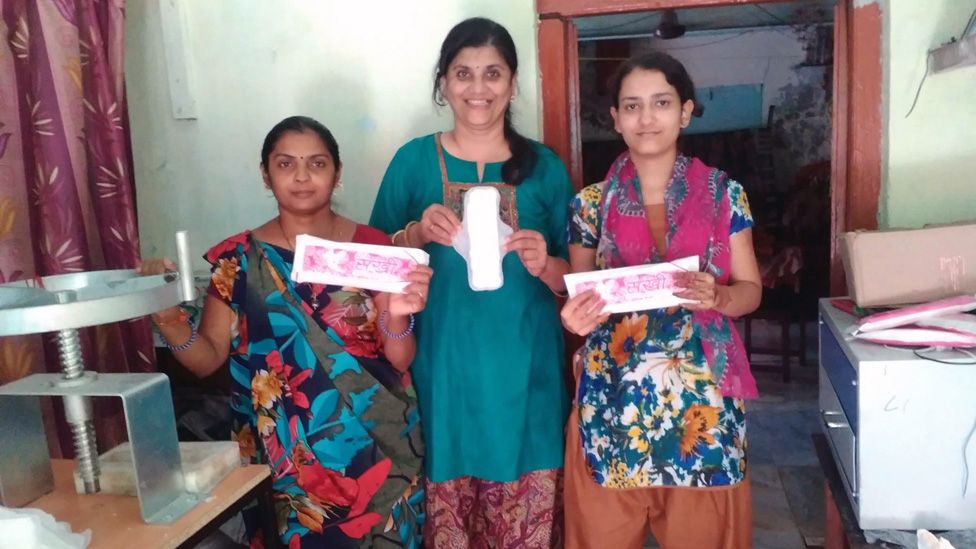 Swati Bedekar (centre) with two women who make sanitary pads