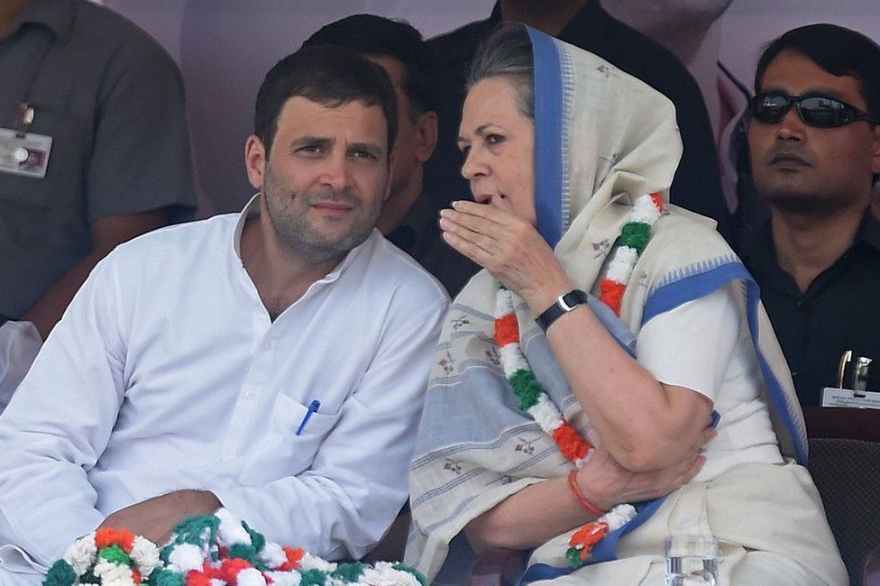 Indian Congress Party vice-president Rahul Gandhi (L) and Congress President Sonia Gandhi talk during a rally in New Delhi on April 19, 2015.