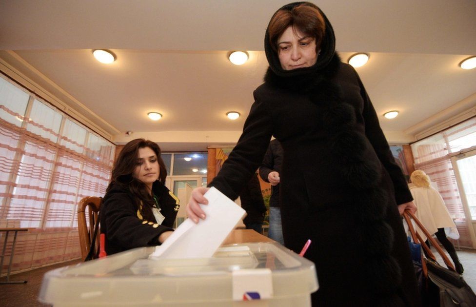 A woman votes during early parliamentary elections in Yerevan on 9 December, 2018