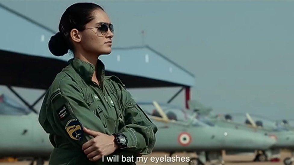 Female pilot stands in front of Indian Air Force planes