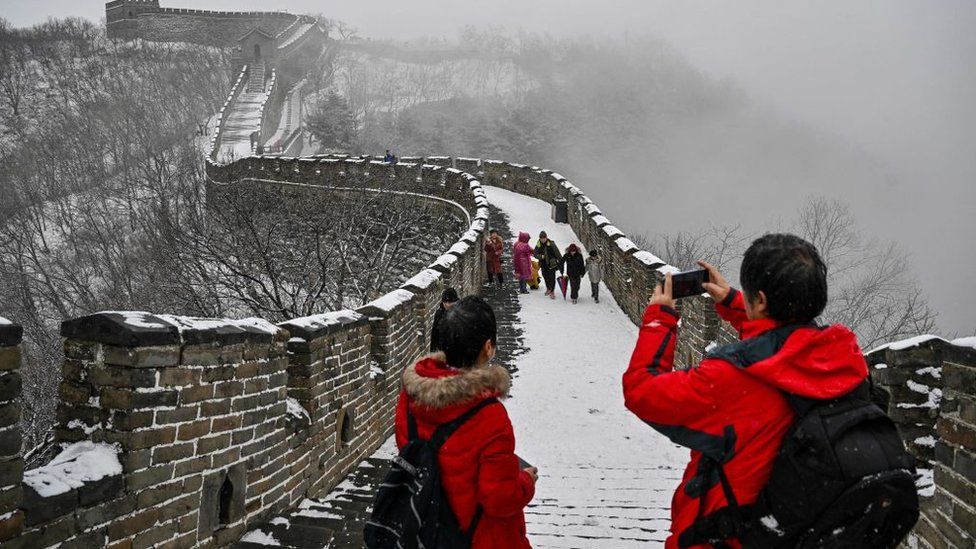 Tourists take pictures of The Great Wall of China.