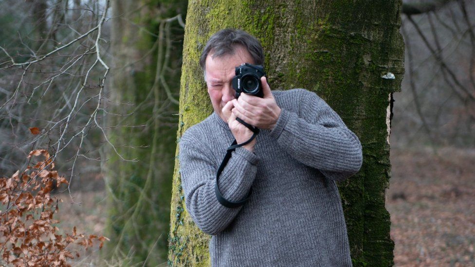Glenn Edwards holding a camera
