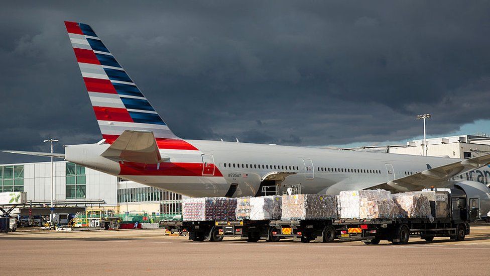 Cargo waits before being loaded on to an aircraft at Heathrow Airport
