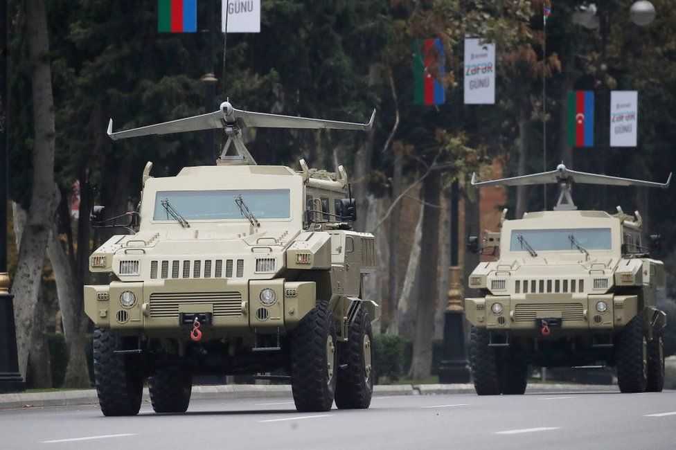 Military vehicles carrying drones made by an Azeri-Israeli joint venture take part in a rehearsal for a military parade in the capital, Baku