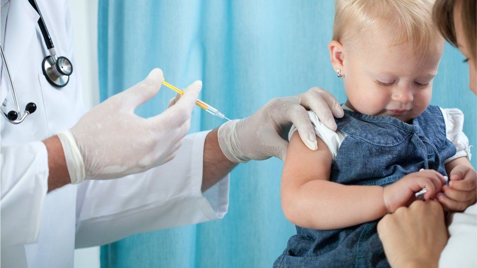 Toddler being given a routine vaccine