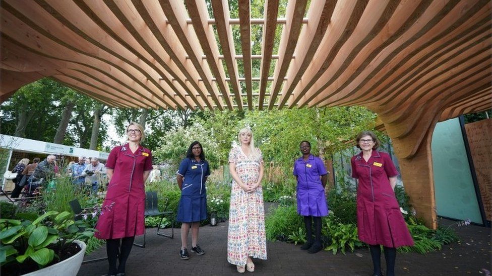 Helen George (centre) in the Florence Nightingale garden at the RHS Chelsea Flower Show 2021